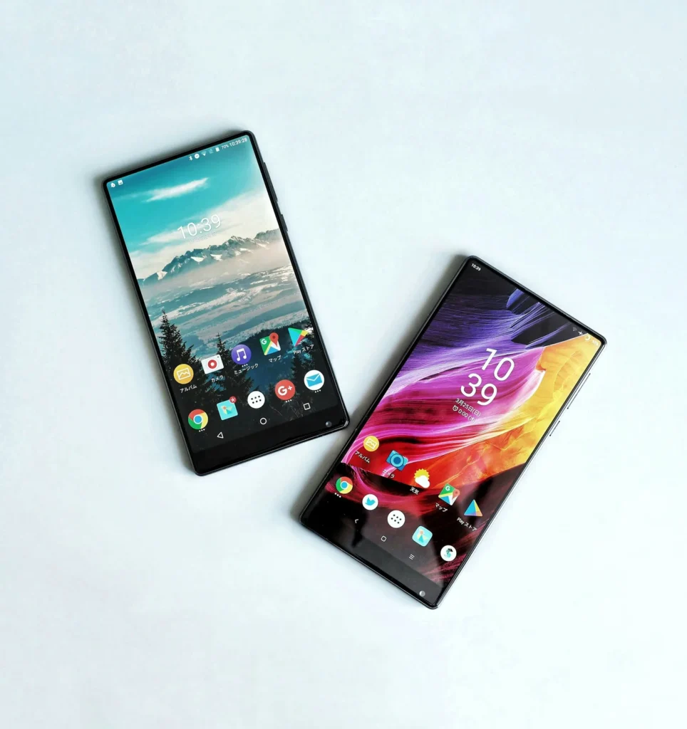 Two smartphones side by side on a white surface