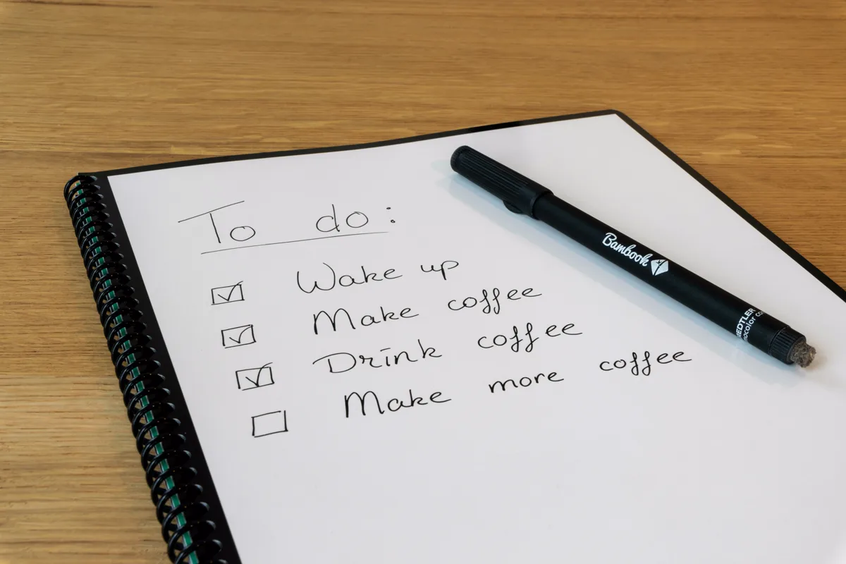 Paper checklist with ticked items on a desk