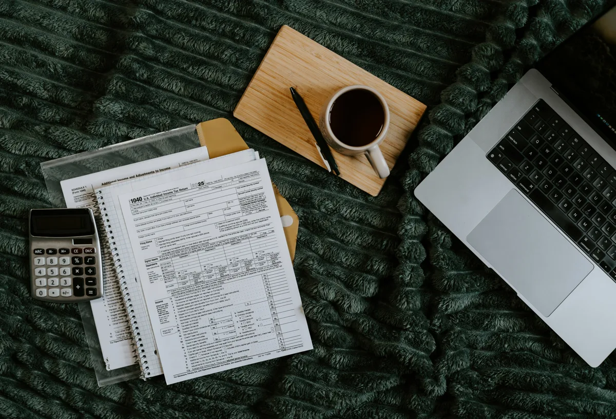 Small business desk with laptop and invoices
